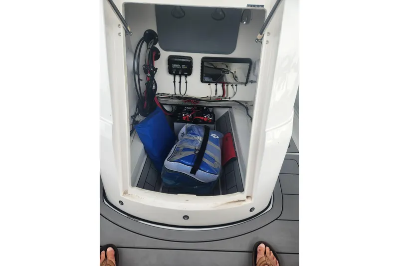 Slide: The Image of 2023 Highfield Sport 900 storage compartment with equipment and wiring. - 18