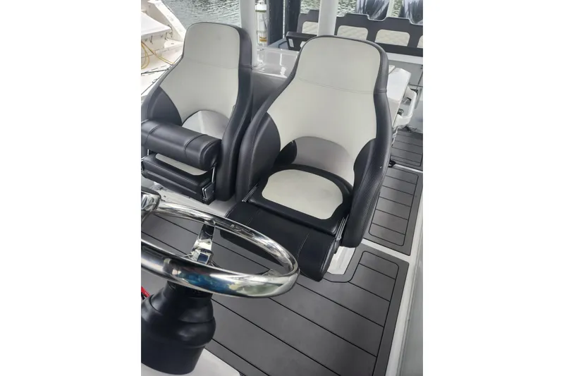 Slide: The Image of 2023 Highfield Sport 900 boat interior with dual black and white seats. - 6