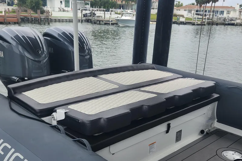 Slide: The Image of 2023 Highfield Sport 900 boat with Yamaha engines, docked by waterfront homes. - 9