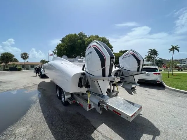 Slide: The Image of 2022 Doug Wright 32 Pleasure Cat boat on trailer with twin outboard engines. - 6