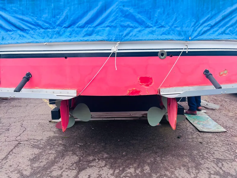 Slide: The Image of 1962 Chris-Craft Roamer boat stern with red hull, blue tarp, and visible propellers. - 11