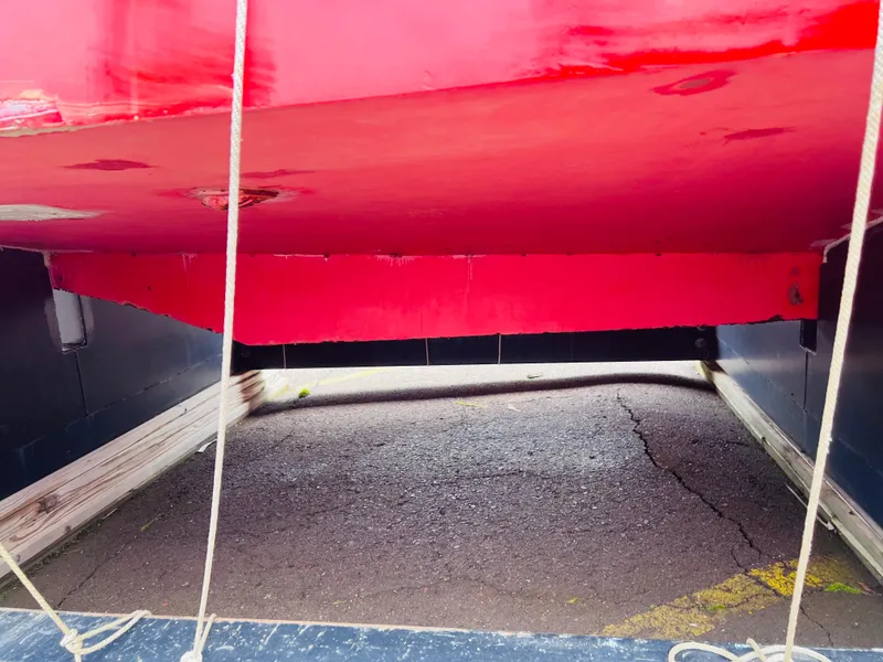 Slide: The Image of Red hull of a 1962 Chris-Craft Roamer boat on a trailer. - 12