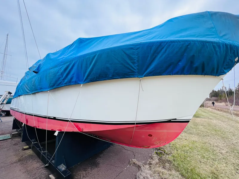Slide: The Image of 1962 Chris-Craft Roamer boat with blue cover, displayed on land. - 15