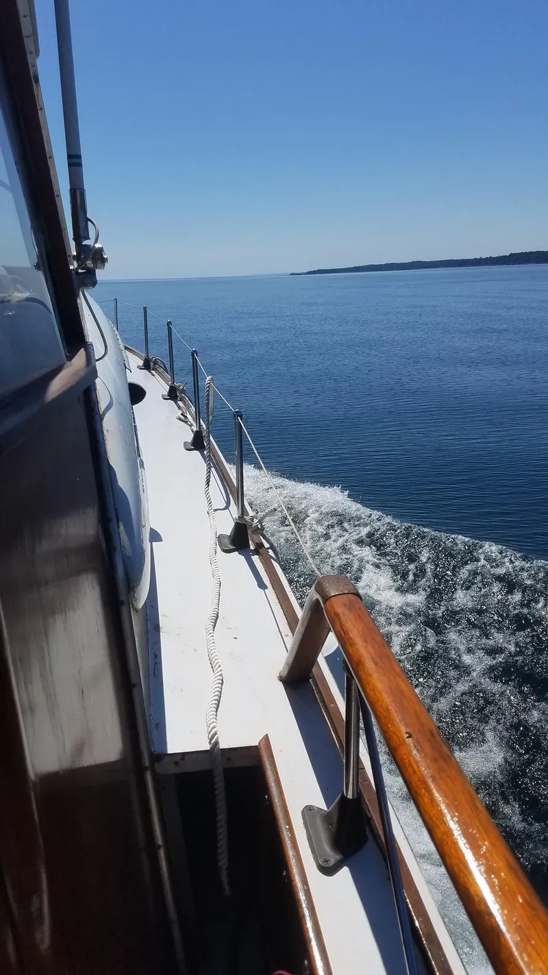 Slide: The Image of 1962 Chris-Craft Roamer cruising on calm blue waters under a clear sky. - 3