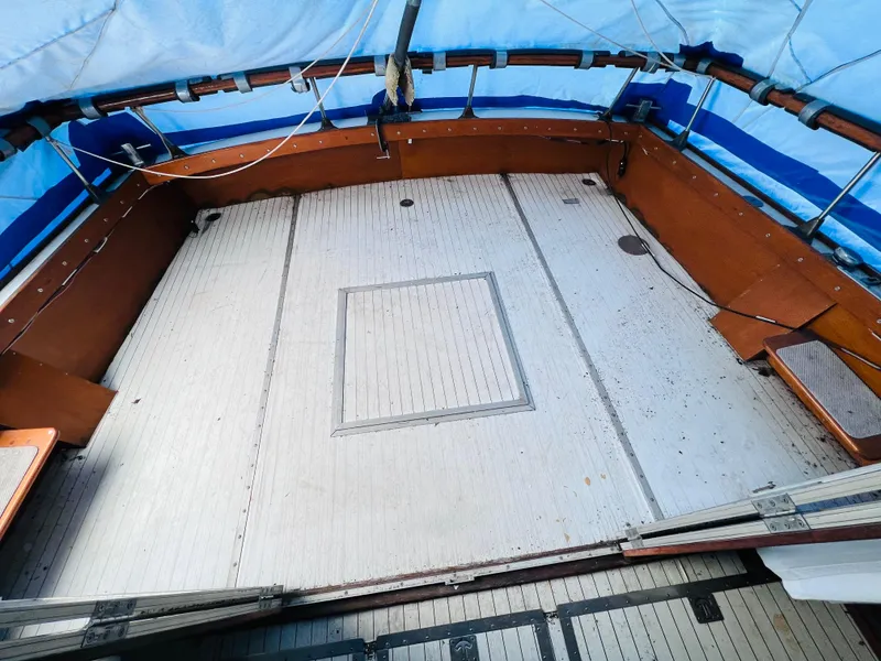 Slide: The Image of 1962 Chris-Craft Roamer boat deck with wooden flooring and blue tarp cover. - 5