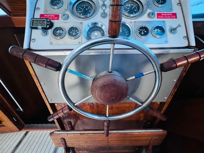 Slide: The Image of 1962 Chris-Craft Roamer steering wheel and dashboard with vintage gauges and controls. - 7