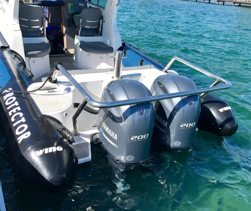 Slide: The Image of 2003 Protector Targa 28 boat with dual Yamaha 200 engines on clear water. - 1