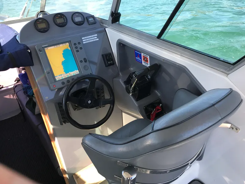 Slide: The Image of Helm of 2003 Protector Targa 28 boat with navigation system and steering wheel. - 11