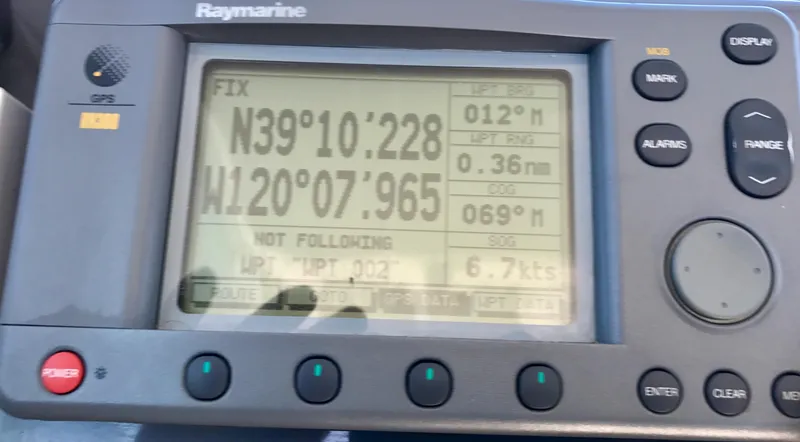 Slide: The Image of Raymarine GPS display on 2003 Protector Targa 28 showing coordinates and speed. - 13