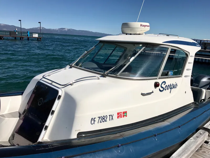 Slide: The Image of 2003 Protector Targa 28 boat docked on a sunny day. - 16