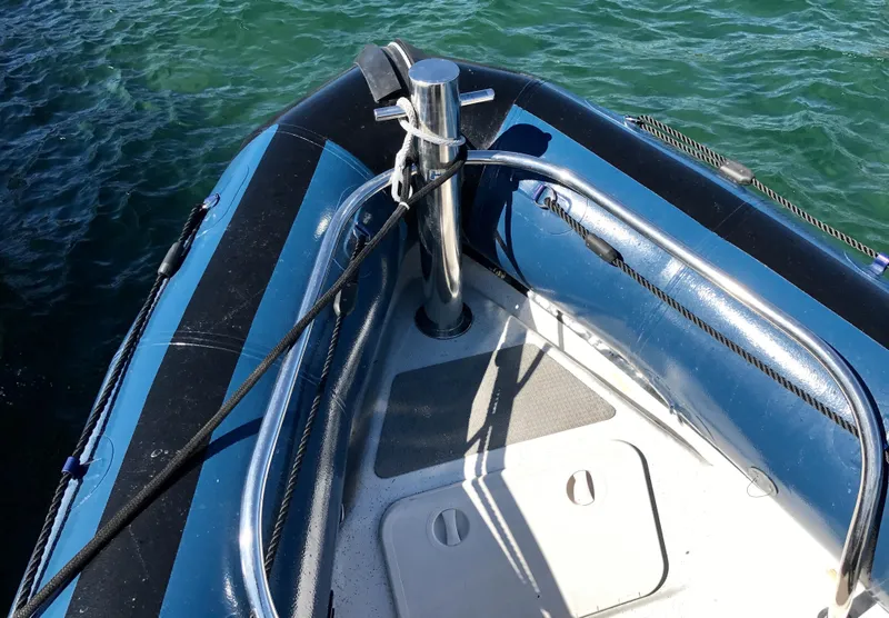 Slide: The Image of 2003 Protector Targa 28 boat bow, moored on water. - 17