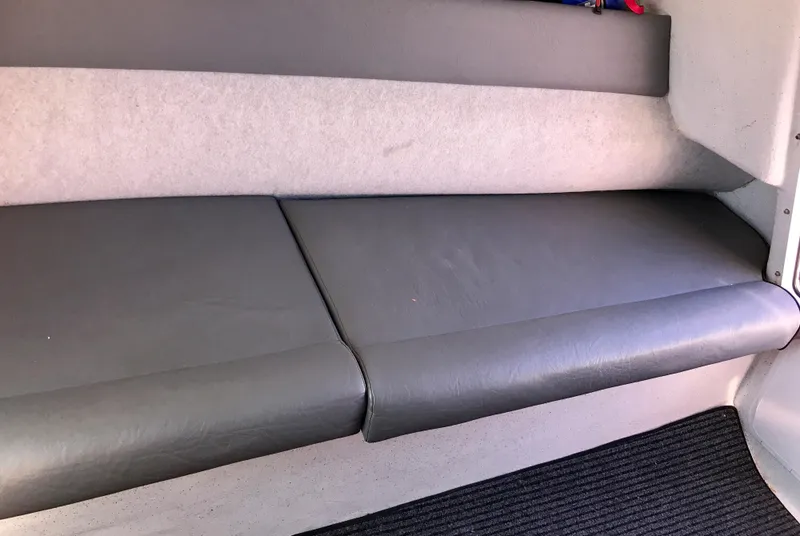 Slide: The Image of Interior seating of 2003 Protector Targa 28 boat, featuring gray cushions. - 18