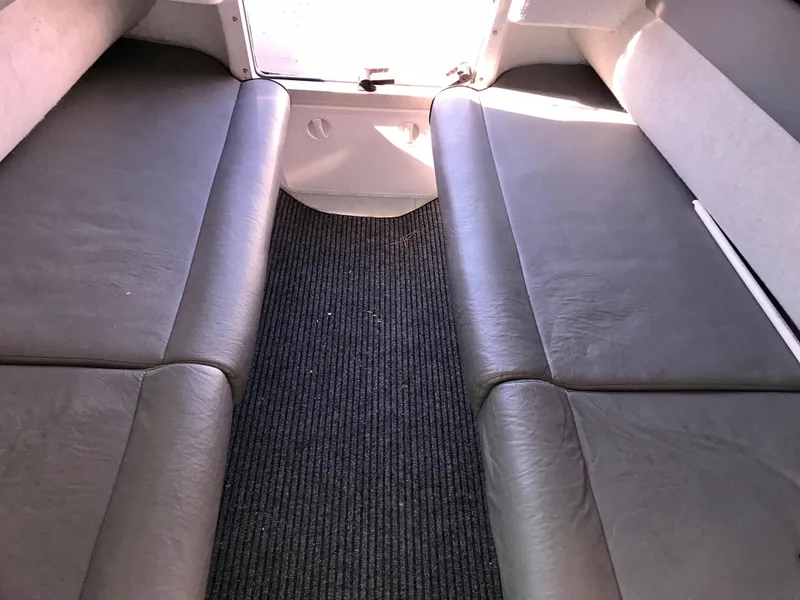 Slide: The Image of Interior cabin of 2003 Protector Targa 28 boat with cushioned seating. - 19