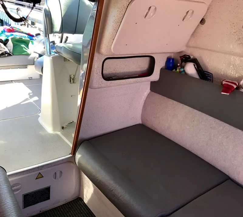 Slide: The Image of Interior of a 2003 Protector Targa 28 boat, featuring seating and storage areas. - 20