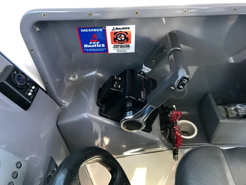 Slide: The Image of Control panel of a 2003 Protector Targa 28 boat with steering wheel and throttle. - 22