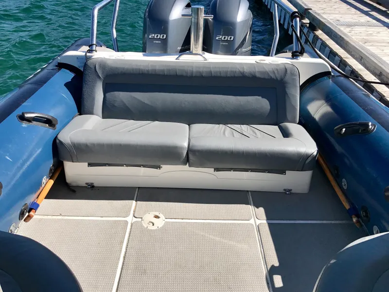 Slide: The Image of 2003 Protector Targa 28 boat with dual engines and cushioned seating. - 28
