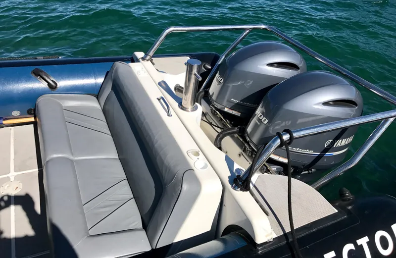 Slide: The Image of 2003 Protector Targa 28 boat with dual Yamaha engines on water. - 29