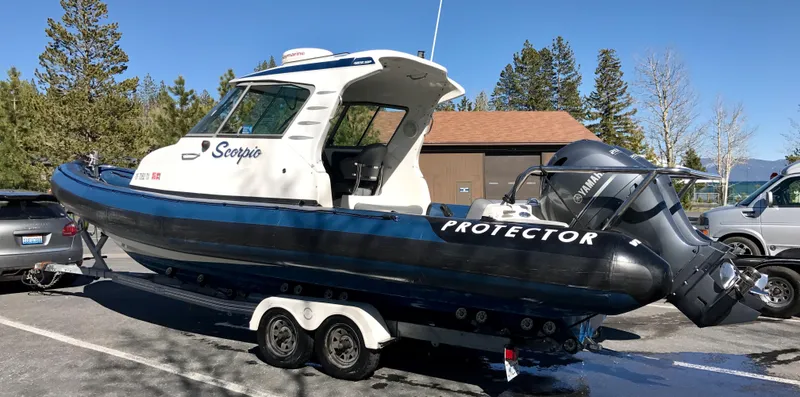 Slide: The Image of 2003 Protector Targa 28 boat on trailer, parked outdoors. - 32