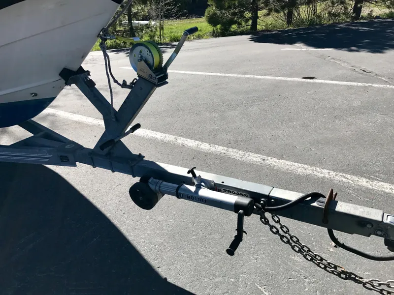 Slide: The Image of Trailer hitch of a 2003 Protector Targa 28 boat in a parking lot. - 35