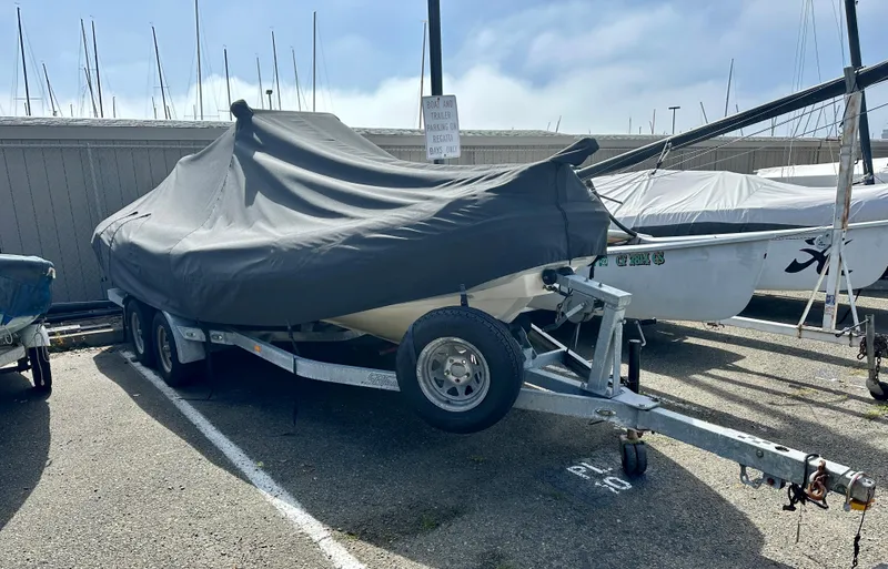 Slide: The Image of Covered 2003 Protector Targa 28 boat on trailer in parking lot. - 38