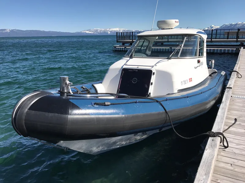 Slide: The Image of 2003 Protector Targa 28 boat docked on a clear, sunny day. - 9