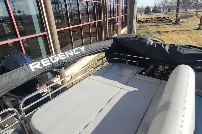 Slide: The Image of 2023 Regency 230 LE3 Sport pontoon boat with covered seating area. - 2