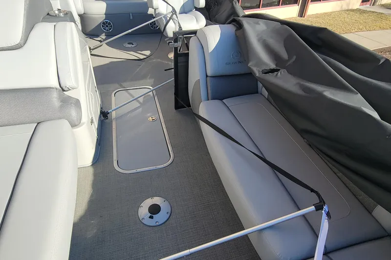 Slide: The Image of 2023 Regency 230 LE3 Sport boat interior with gray seating and storage compartments. - 3