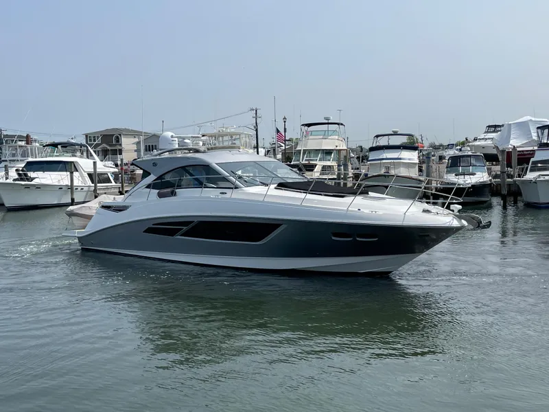 Slide: The Image of A 2018 Sea Ray Sundancer 510 cruising through a busy marina. - 14