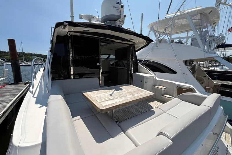 Slide: The Image of 2018 Sea Ray Sundancer 510 yacht with outdoor seating and table at marina. - 93