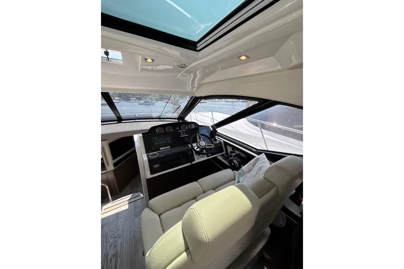Slide: The Image of Interior cockpit of 2018 Sea Ray Sundancer 510 yacht with modern controls and seating. - 107