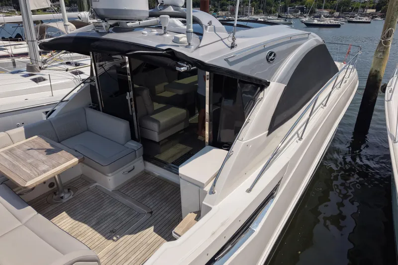 Slide: The Image of 2018 Sea Ray Sundancer 510 yacht docked, featuring spacious seating and sleek design. - 81