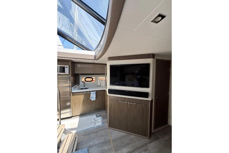 Slide: The Image of Luxurious interior of 2018 Sea Ray Sundancer 510 yacht with modern kitchen and entertainment area. - 128