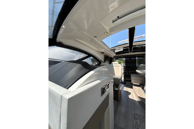 Slide: The Image of Interior view of 2018 Sea Ray Sundancer 510 yacht, featuring luxurious seating and modern design. - 100