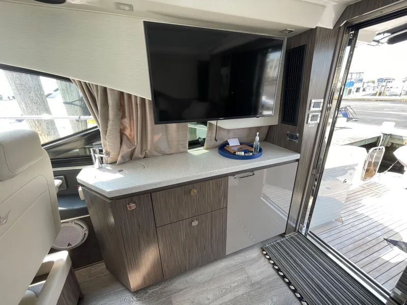 Slide: The Image of Interior of a 2018 Sea Ray Sundancer 510 with a modern entertainment area and sleek furnishings. - 52