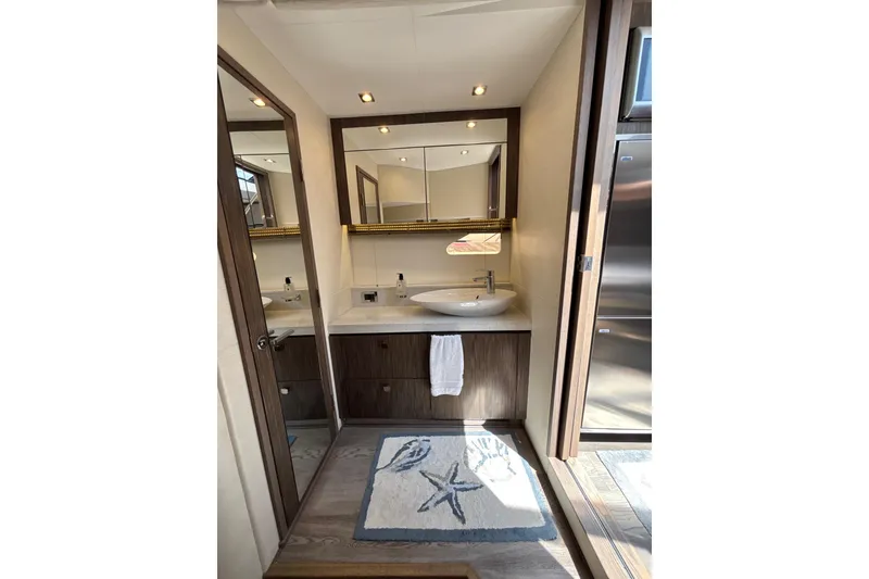 Slide: The Image of Luxurious bathroom in 2018 Sea Ray Sundancer 510 yacht with modern fixtures and starfish-themed decor. - 136