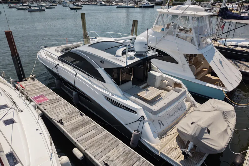 Slide: The Image of 2018 Sea Ray Sundancer 510 yacht docked at marina, surrounded by other boats. - 77