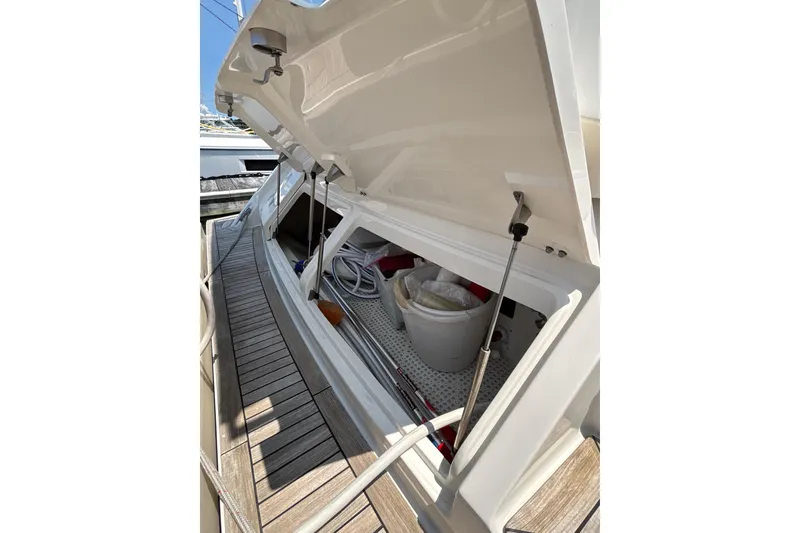 Slide: The Image of Open storage compartment on 2018 Sea Ray Sundancer 510 yacht, showing interior equipment. - 146