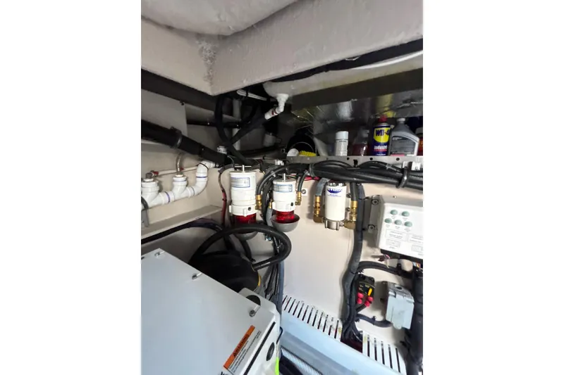 Slide: The Image of Engine room of 2018 Sea Ray Sundancer 510 with visible fuel filters and wiring. - 119