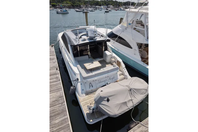 Slide: The Image of 2018 Sea Ray Sundancer 510 yacht docked at marina, rear view. - 86