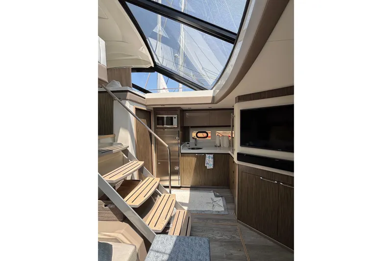Slide: The Image of Luxurious interior of 2018 Sea Ray Sundancer 510 yacht with modern kitchen and skylight. - 127