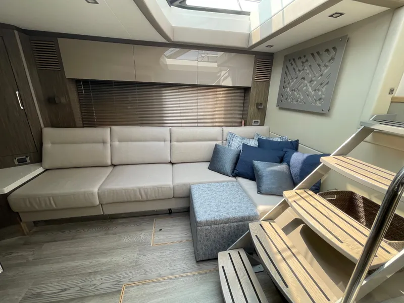 Slide: The Image of The image shows the interior of a 2018 Sea Ray Sundancer 510 with an elegant seating area. - 57