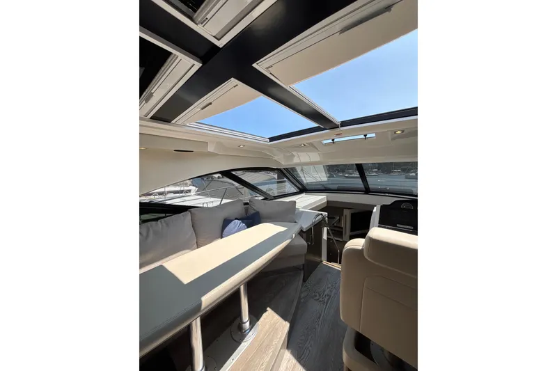 Slide: The Image of Luxurious interior of 2018 Sea Ray Sundancer 510 yacht with skylight and seating area. - 97