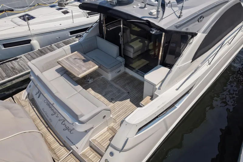 Slide: The Image of 2018 Sea Ray Sundancer 510 yacht with spacious deck and seating area at marina. - 80