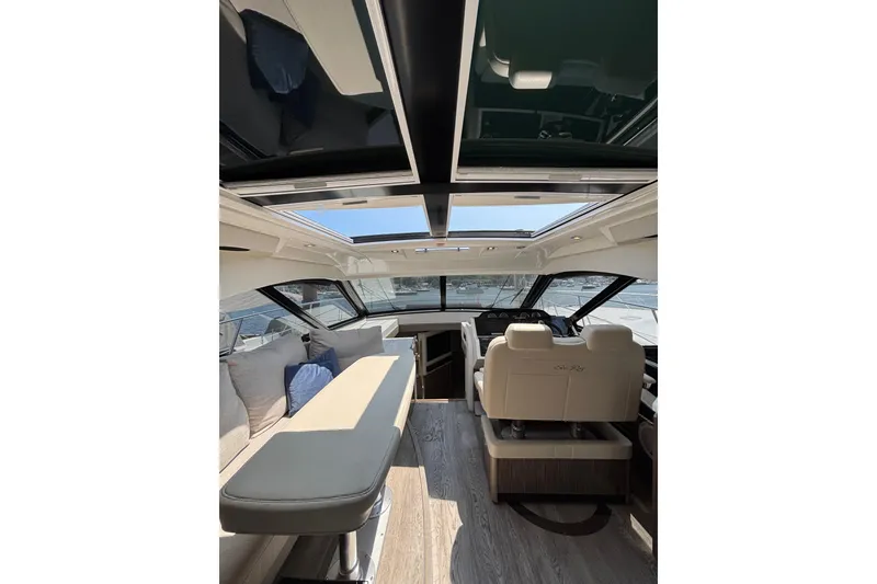 Slide: The Image of Interior of 2018 Sea Ray Sundancer 510 yacht with luxurious seating and panoramic windows. - 101