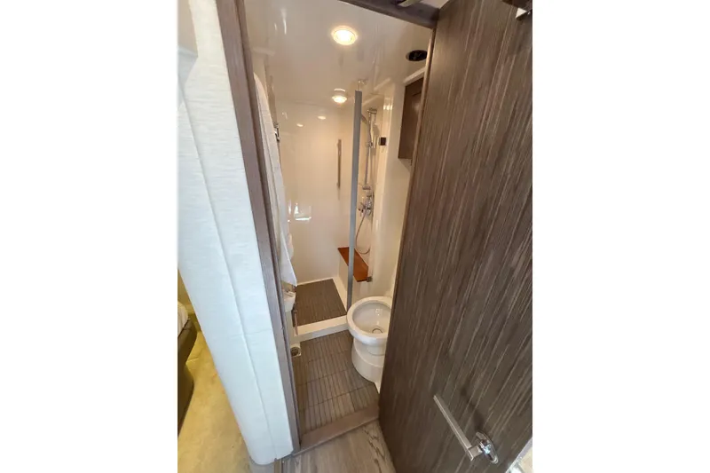 Slide: The Image of 2018 Sea Ray Sundancer 510 yacht bathroom with modern fixtures and wood accents. - 135