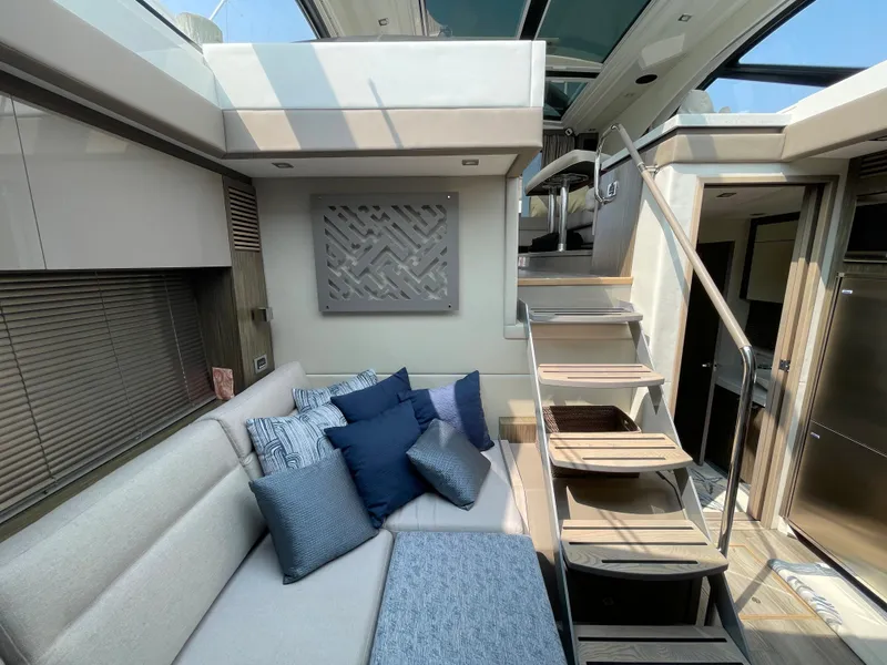 Slide: The Image of Interior of a 2018 Sea Ray Sundancer 510 with stylish cushions and a modern staircase. - 58