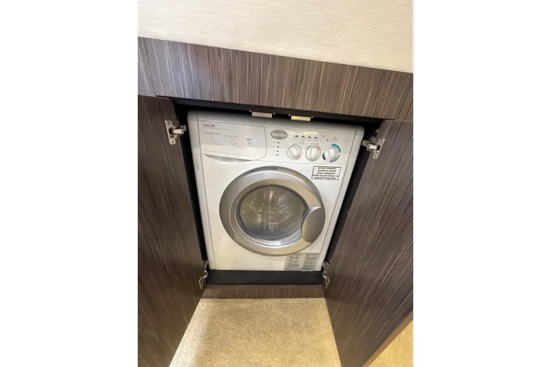 Slide: The Image of Built-in washing machine on 2018 Sea Ray Sundancer 510 yacht, behind wooden cabinet door. - 143