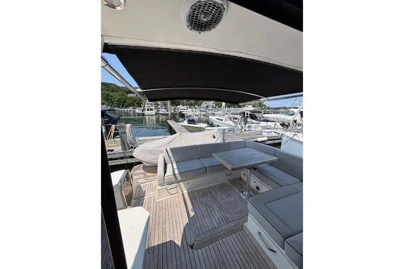 Slide: The Image of 2018 Sea Ray Sundancer 510 yacht with spacious deck seating and marina view. - 91