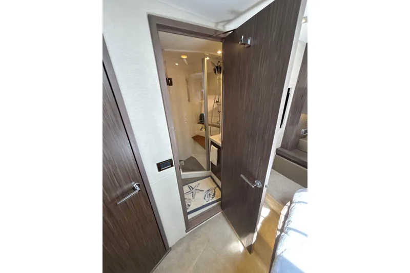 Slide: The Image of Interior view of 2018 Sea Ray Sundancer 510 yacht bathroom with open door. - 132
