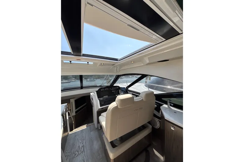 Slide: The Image of Interior of 2018 Sea Ray Sundancer 510 yacht with modern helm and panoramic windows. - 98
